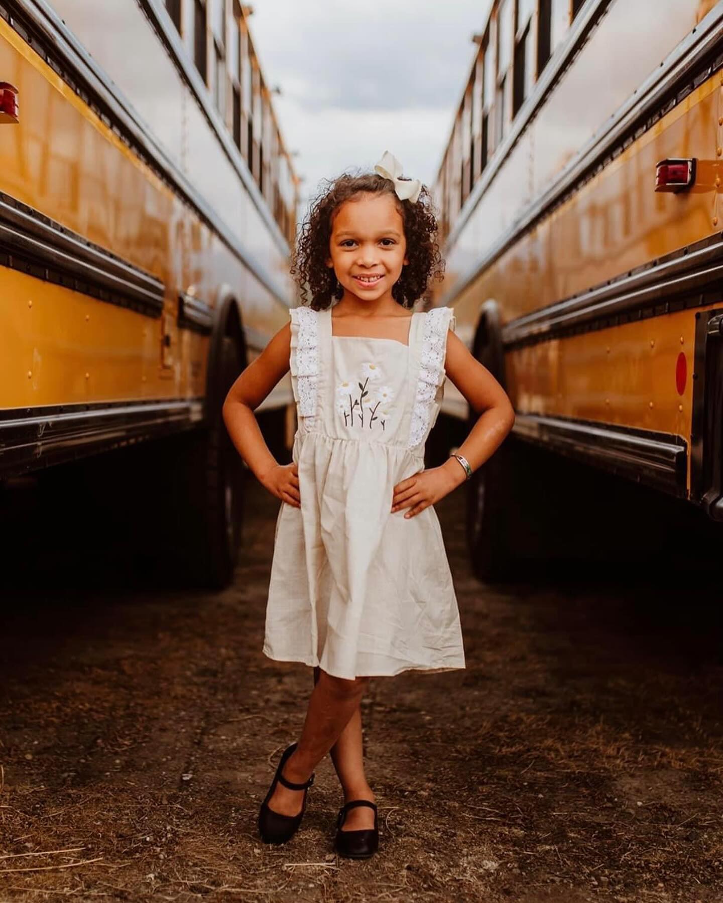 girl back to school photos with school busses